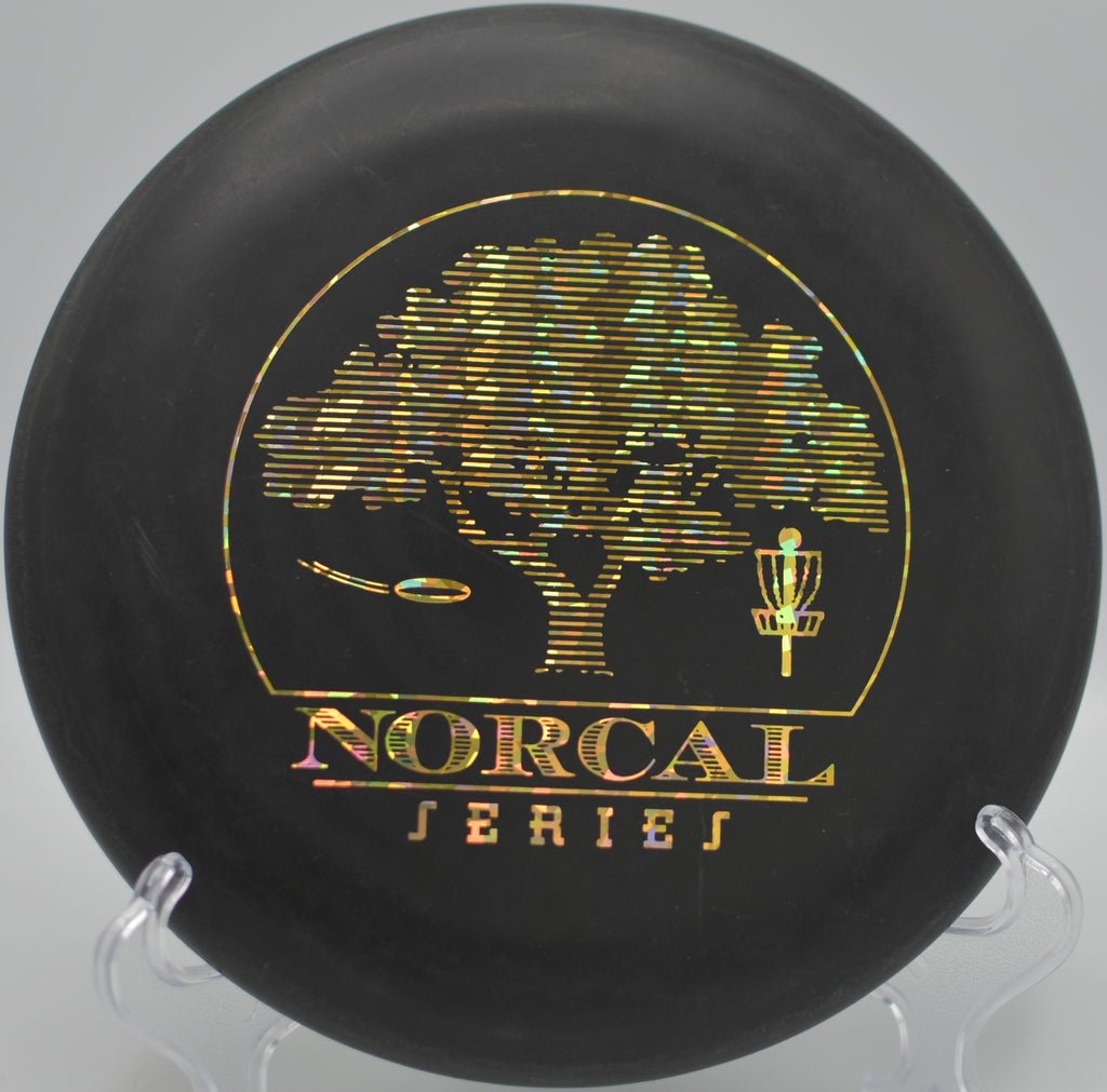 Black 2-Ring San Marino Big Bead DX Aviar w/Pat# spinning toward the basket at DeLaveaga Disc Golf Course in Santa Cruz, California.