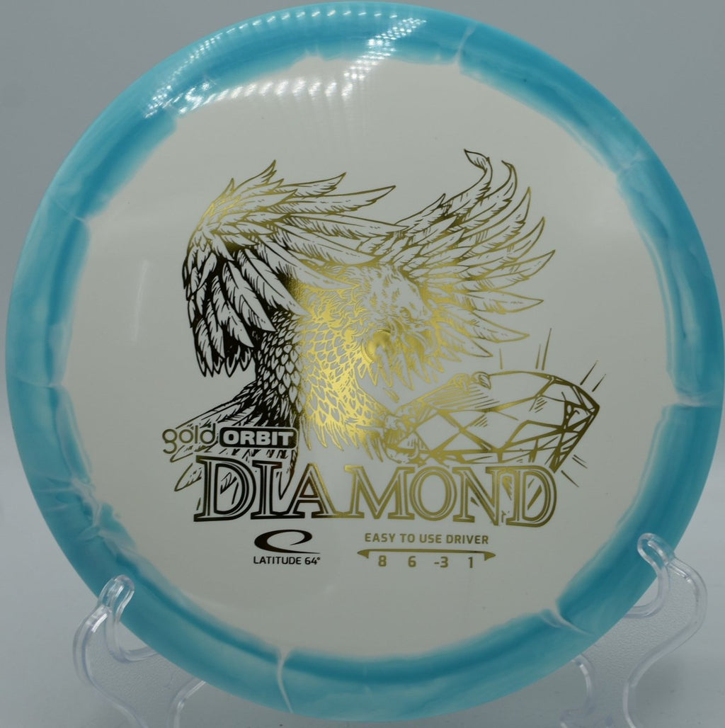 Latitude 64 Gold Orbit Diamond driver displayed on grass at Sandy Point Disc Golf Ranch in Lac du Flambeau, Wisconsin