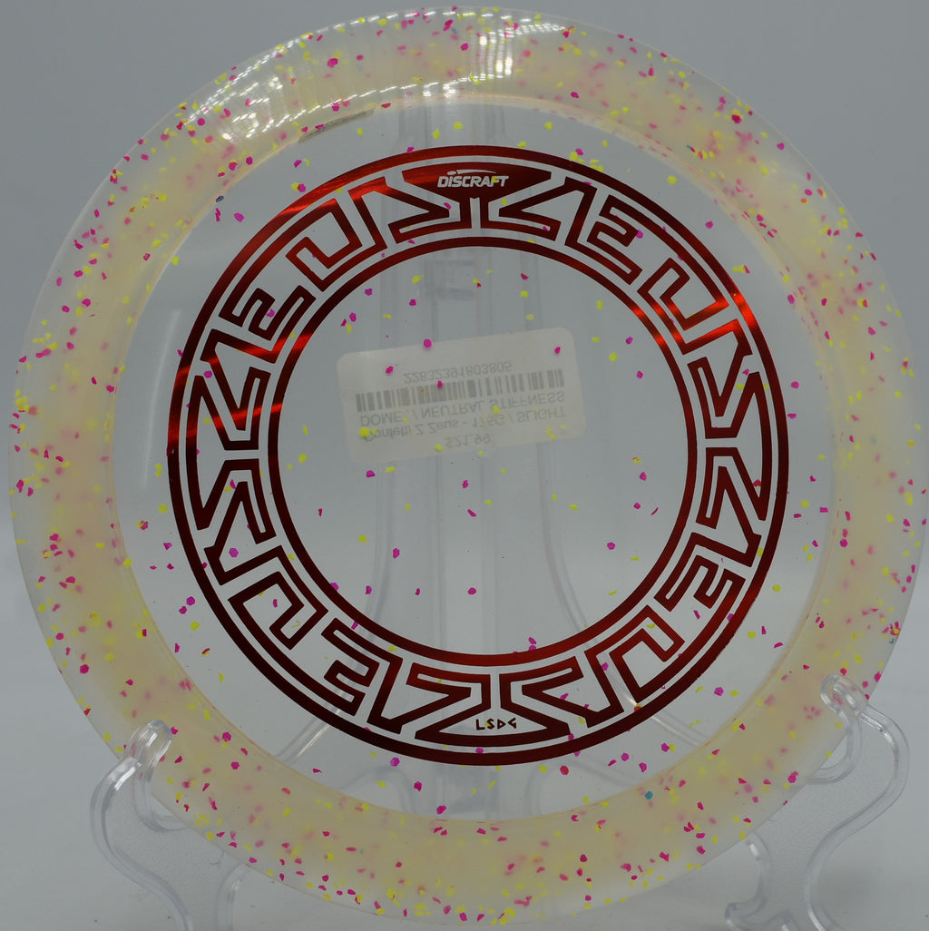 Z Confetti Zeus glowing under bright sun at North Cove Disc Golf Course in Marion, North Carolina