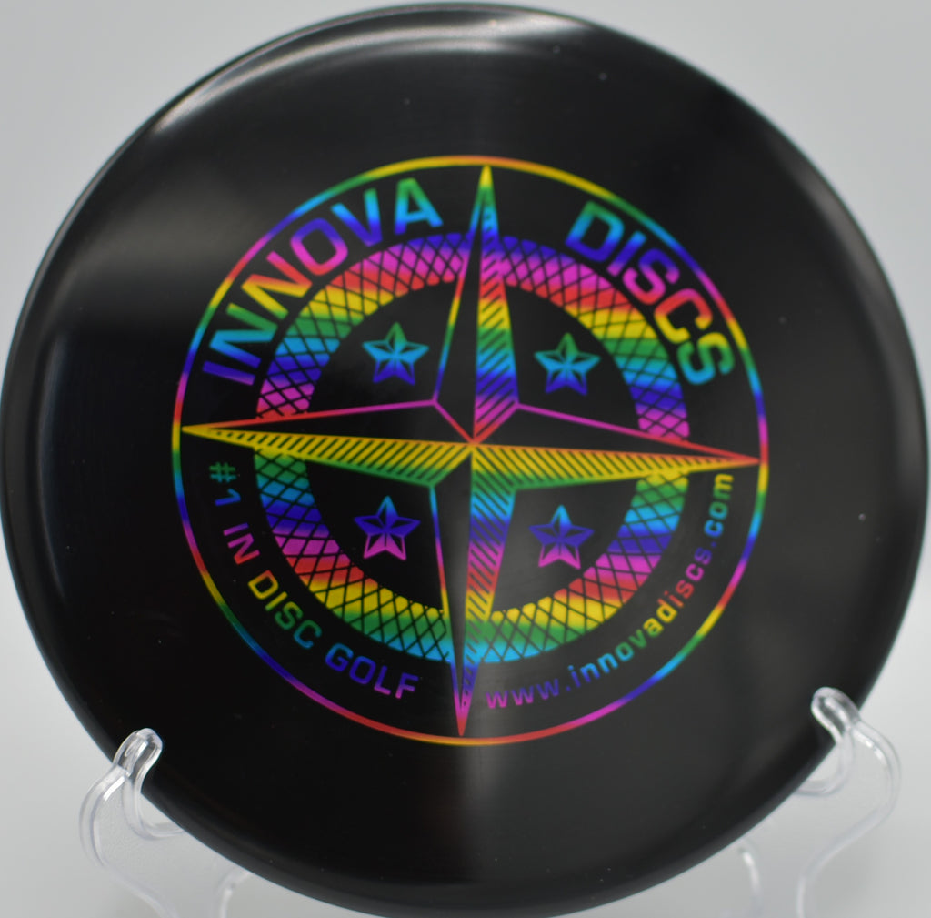 Proto Star Rat landing softly beside the basket after a controlled upshot at Blue Ribbon Pines Disc Golf Course in East Bethel, Minnesota.

