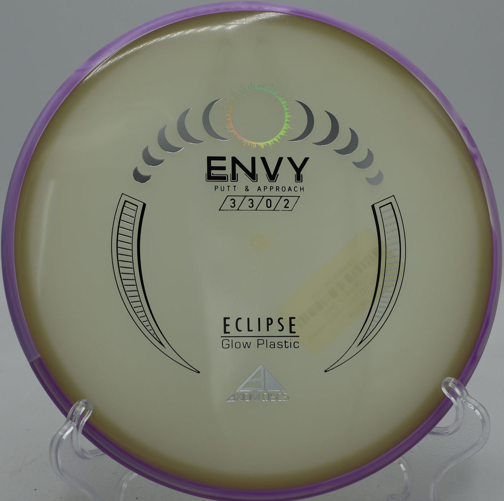 Eclipse Envy MVP glow putter settling beside the pin at Northwood Black Disc Golf Course in Morton, Illinois.