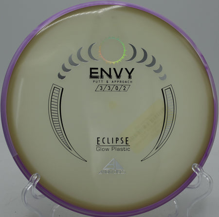 Eclipse Envy MVP glow putter settling beside the pin at Northwood Black Disc Golf Course in Morton, Illinois.