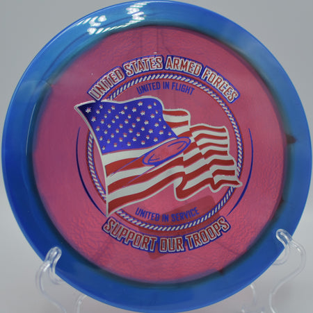 Halo Champion Firebird Support Our Troops edition staged on the wooded lane at Sequoyah Park DGC in Knoxville, TN, emphasizing its overstable skip-shot capability.