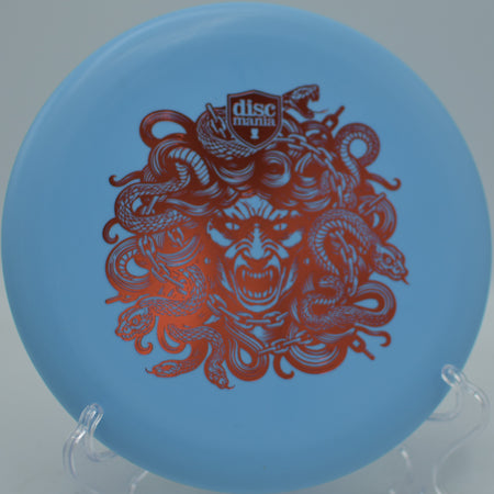 Exo Soft Lumen Link Medusa glow putter sticking near the basket at Harmon Hills Disc Golf Course in Fall Branch, Tennessee.