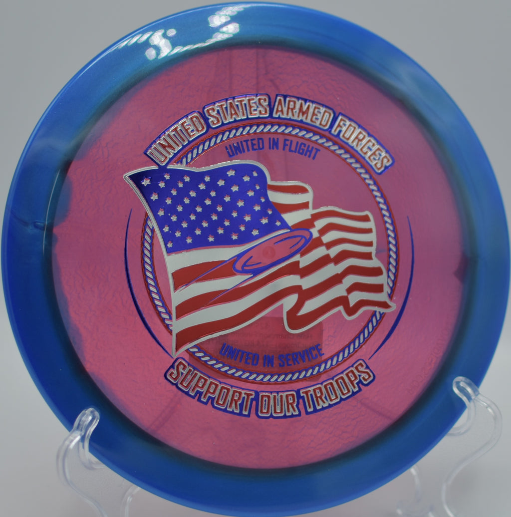 Innova Support Our Troops Halo Firebird resting beside the chains at Heritage Park DGC in Belton, KS, perfect for controlled hyzer finishes.