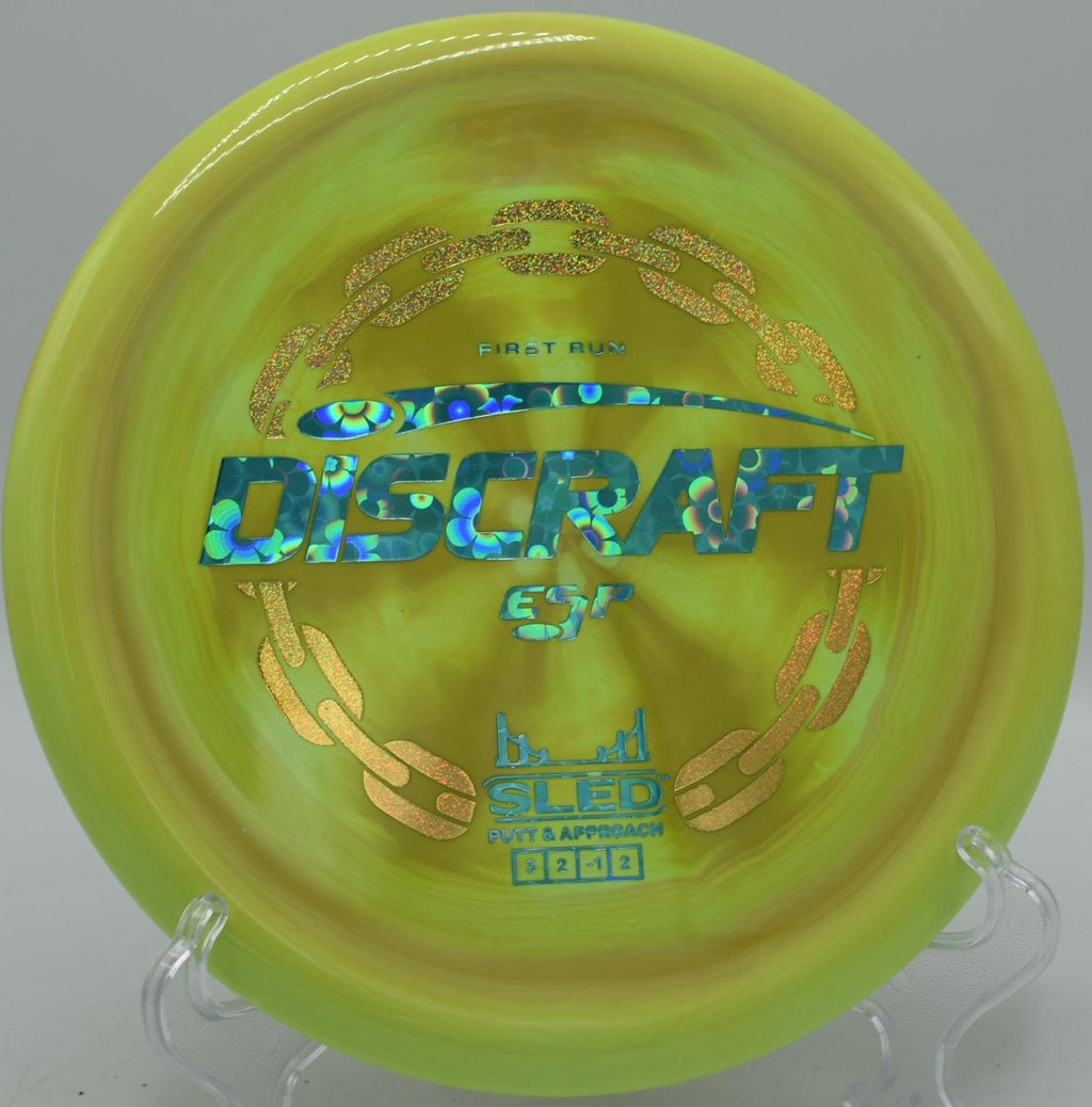 First Run ESP Sled straight approach shot finishing near basket at Sandy Hollow Disc Golf Course in Rockford, Illinois