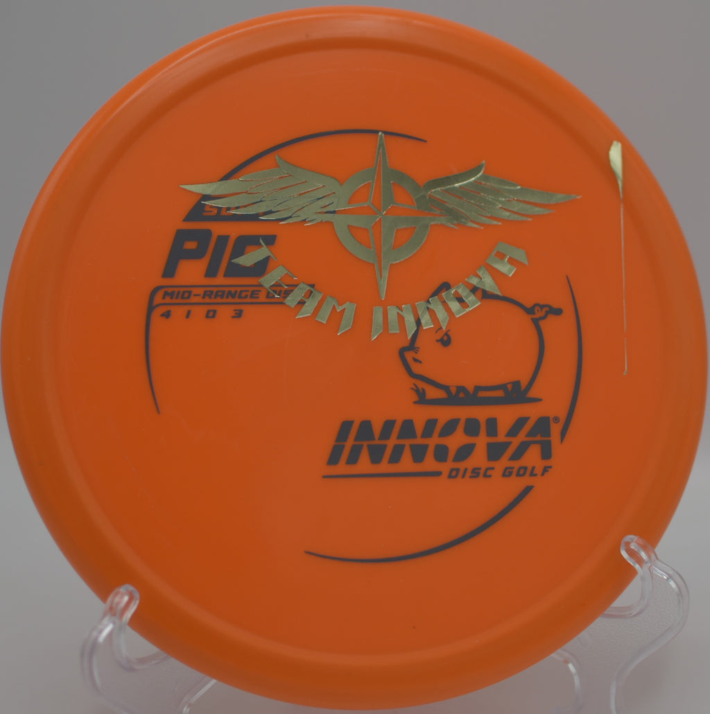 Player flicking a Soft Pro Pig Team Stamp forehand upshot toward the basket at Blue Ribbon Pines Disc Golf Course in East Bethel, Minnesota.