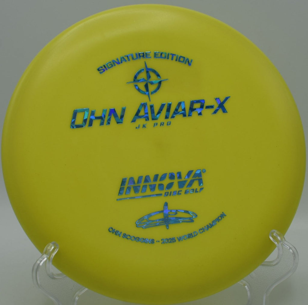 JK Aviar-X putter resting near chains after a glidey upshot at Maple Hill Red Course Disc Golf Course in Leicester, Massachusetts