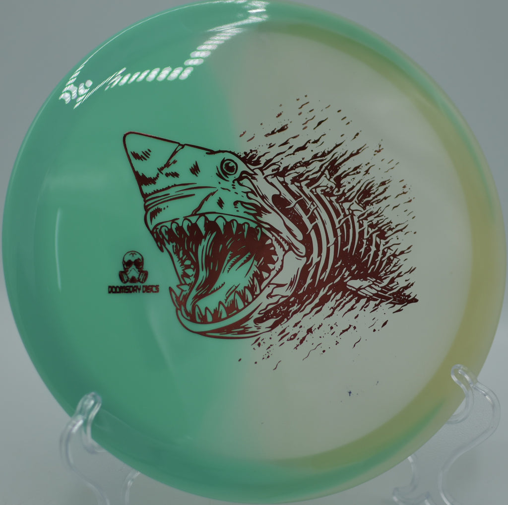 Glow Chemtrail resting on a rocky tee pad at Rockness Monster DGC in Oconomowoc, WI, great for controlled turnovers.