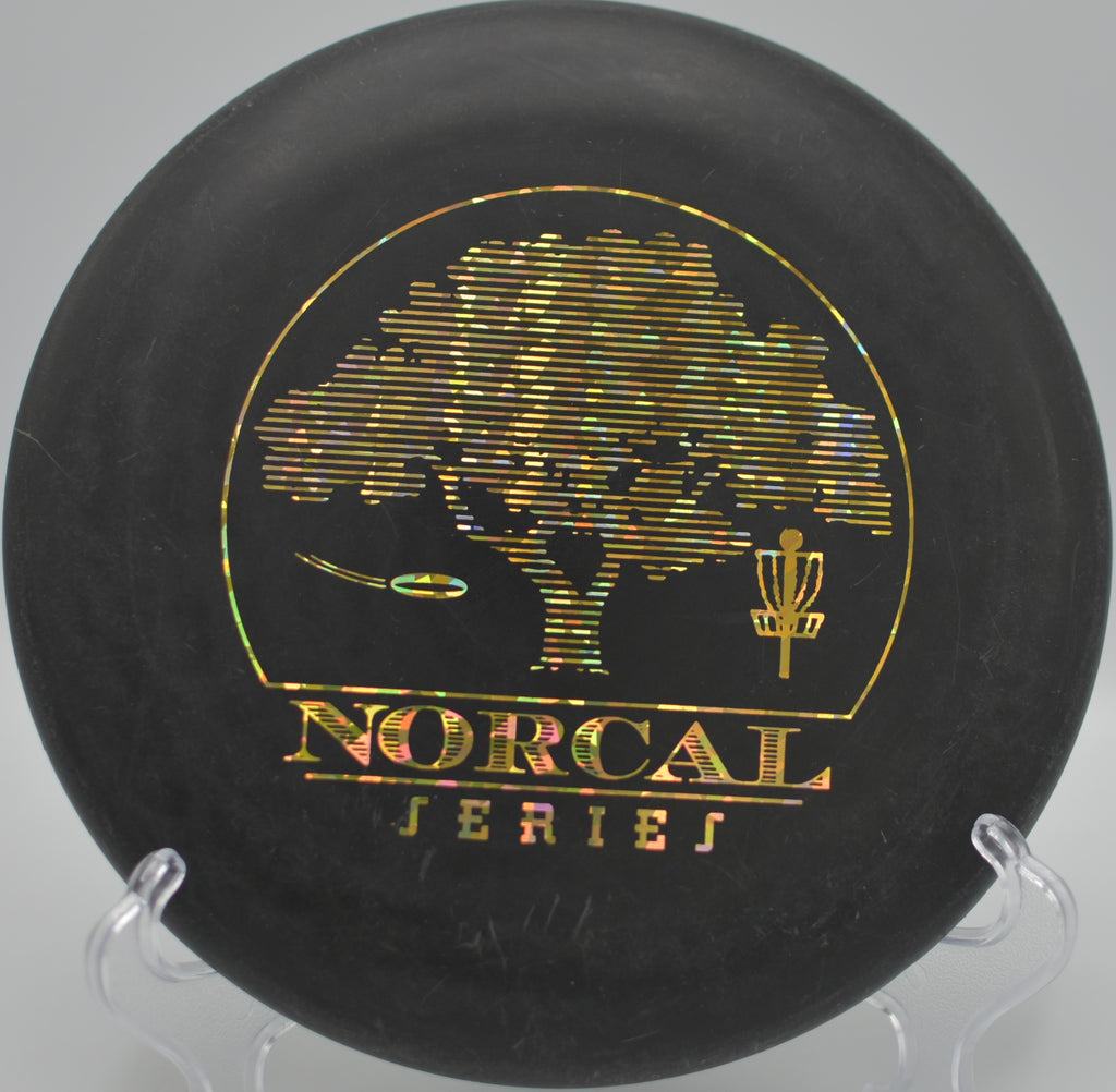 Black 2-Ring San Marino Big Bead DX Aviar w/Pat# parked under the pin after a clean hyzer putt at La Mirada Regional Park Disc Golf Course in La Mirada, California.