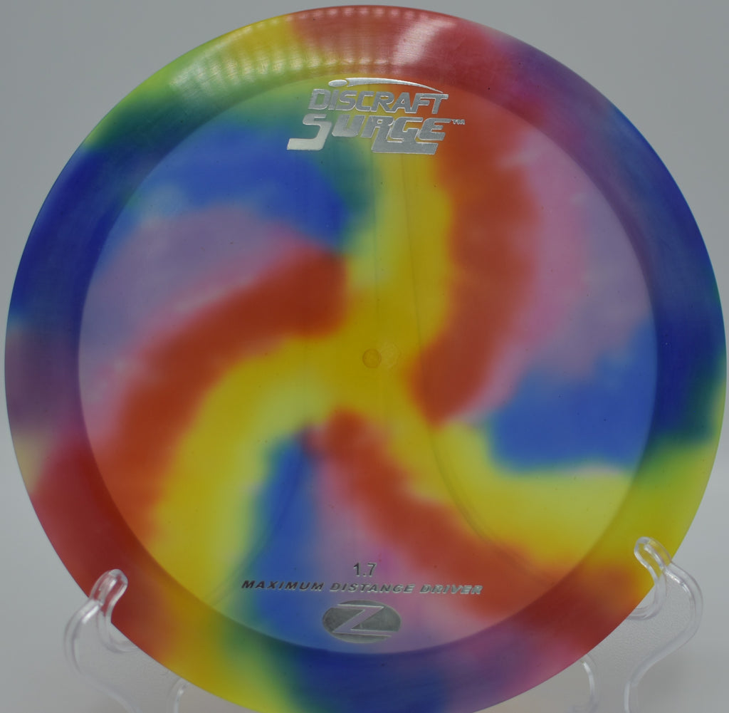 PFN Z FlyDye Surge blasting down the fairway at Owl Creek Disc Golf Course in Virginia Beach, Virginia, showing its high-speed glide and vibrant FlyDye coloration in flight.