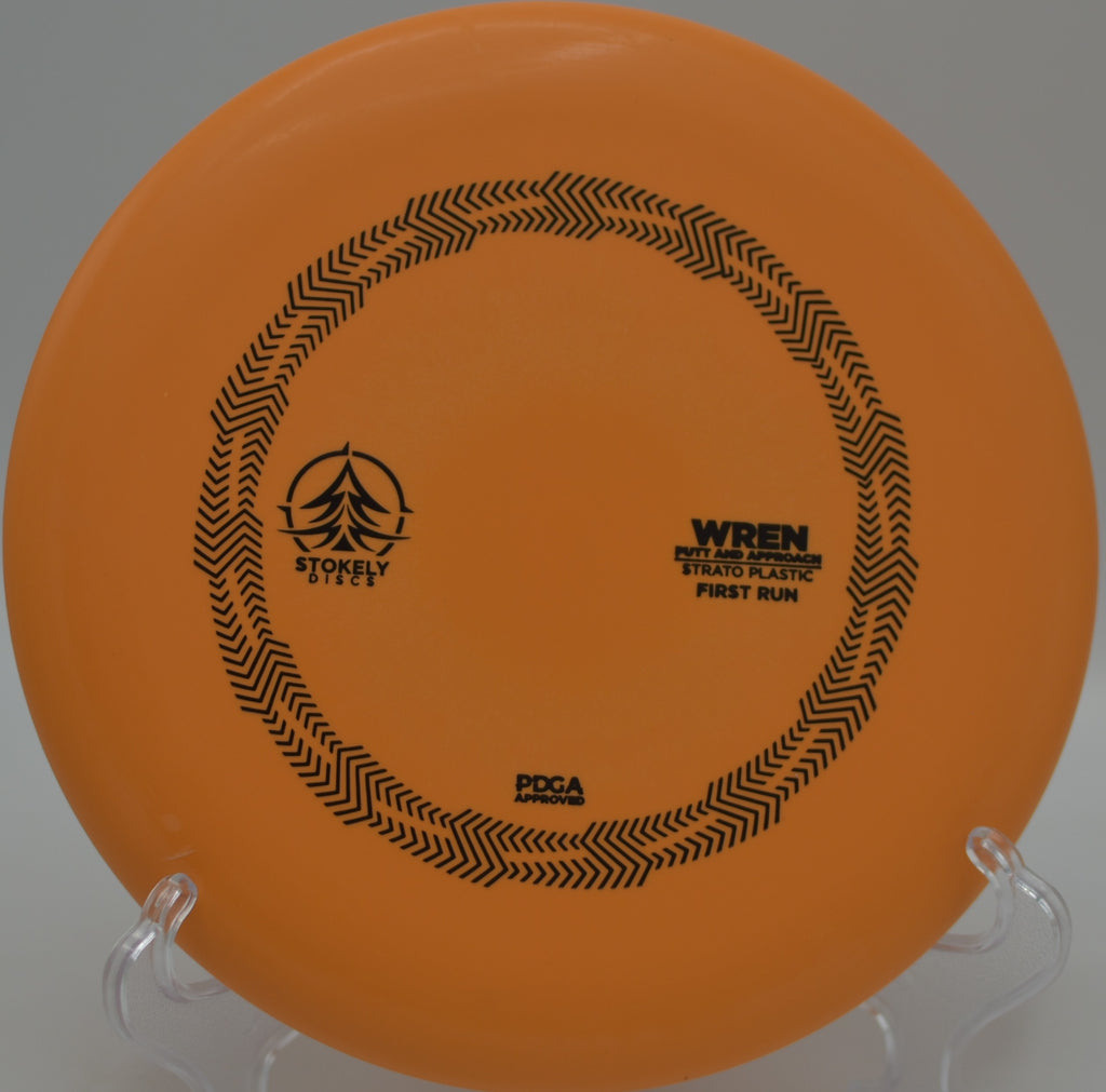 Stokely Strato Wren flying clean and flat through a wooded lane at Brewer Park Disc Golf Course in Grand Rapids, Michigan.