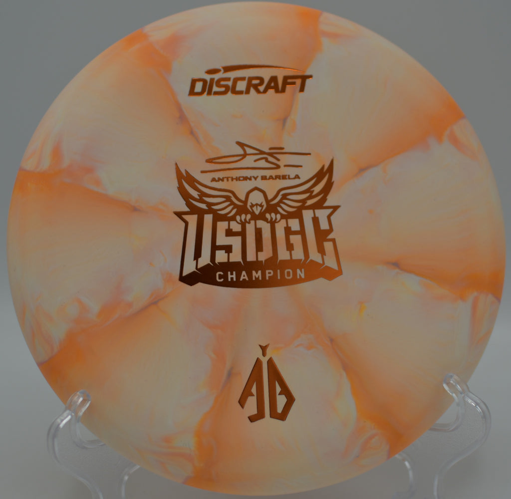 Discraft CT Swirl Focus beside basket three at Hogan Park DGC in Midland, TX, great for consistent fade control.