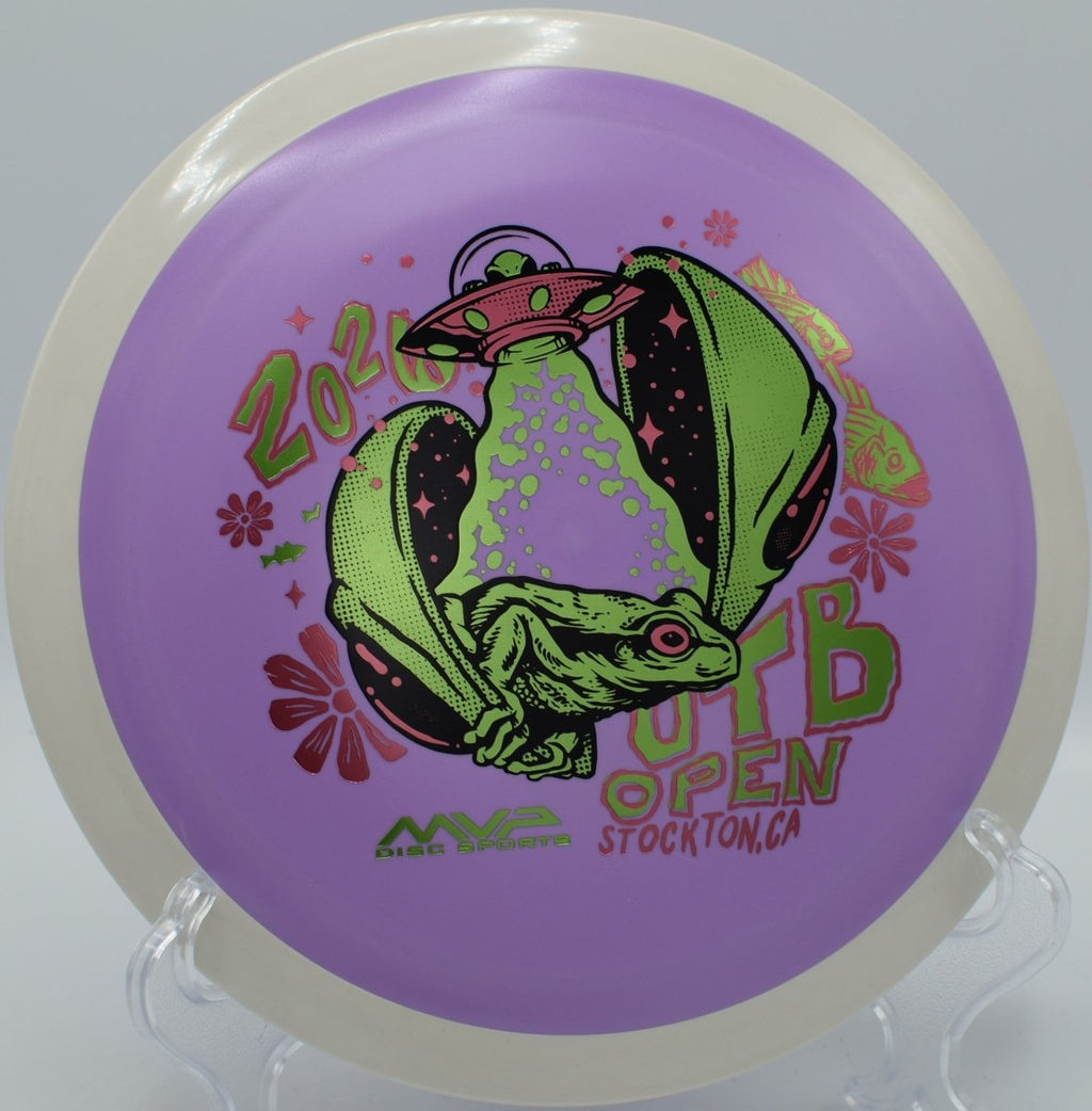 2026 OTB Open Fission Delirium driver resting on log obstacle at Fort Steilacoom Disc Golf Course in Lakewood, Washington