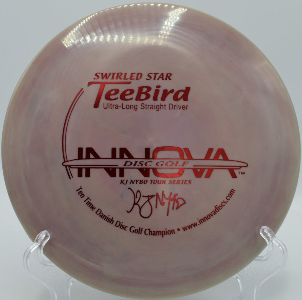 KJ Nybo Swirly Star TeeBird fairway driver driving a low, controlled line through rolling terrain at Lake Marshall Disc Golf Course in Montross, Virginia, maintaining torque-resistant stability, forward carry, and a confident finish for accurate disc golf tee work