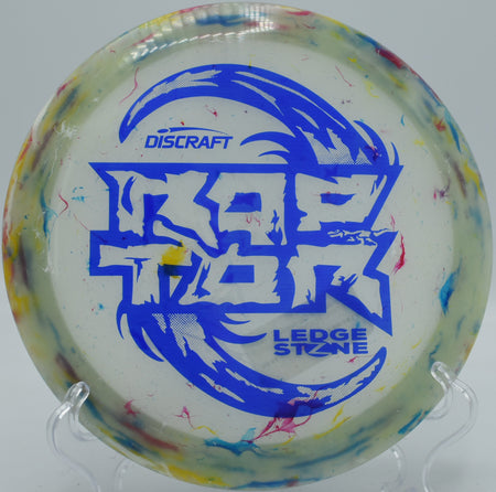 Jawbreaker Z Glo Raptor glowing under UV light at night round on the BlueGill course in Wayland, Michigan