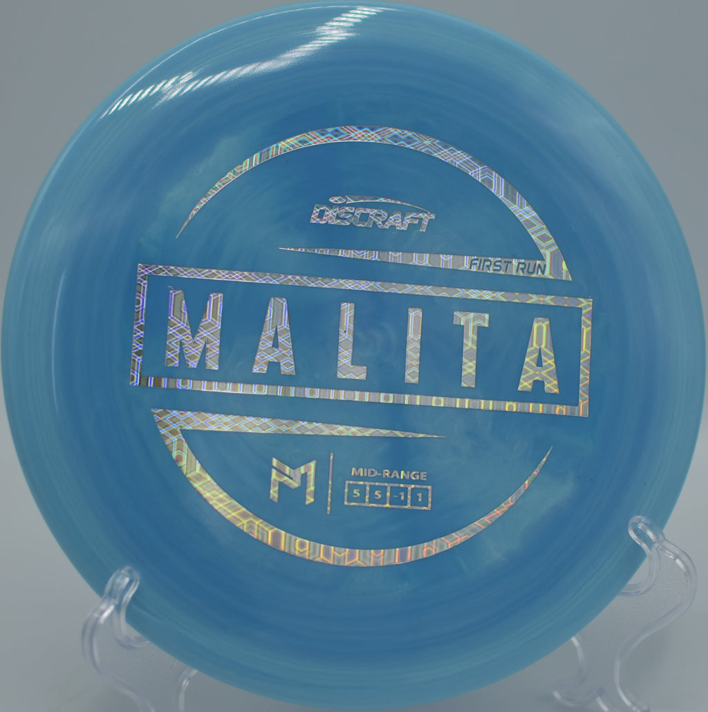 Player shaping a technical midrange shot with the McBeth First Run Malita at Shoaff Park Disc Golf Course in Fort Wayne, Indiana.