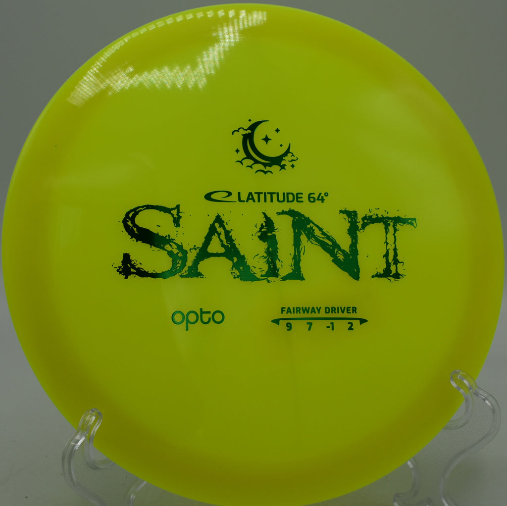 Opto Moonshine Saint Latitude 64° glowing fairway driver threading wooded fairways at Northwood Black Disc Golf Course in Morton, Illinois.