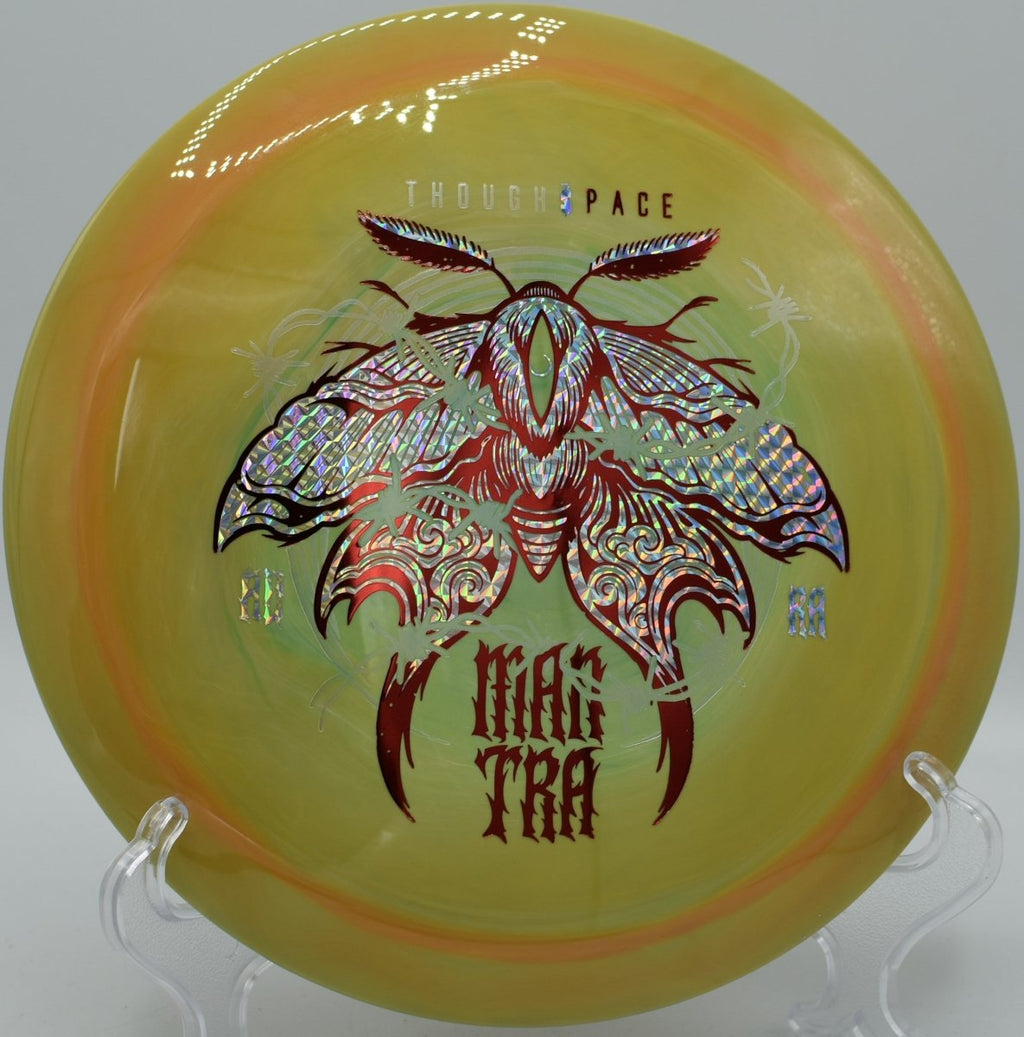 Mantra fairway driver gliding on a long turnover line through wooded fairway at Hickory Hills Disc Golf Course in Traverse City, Michigan