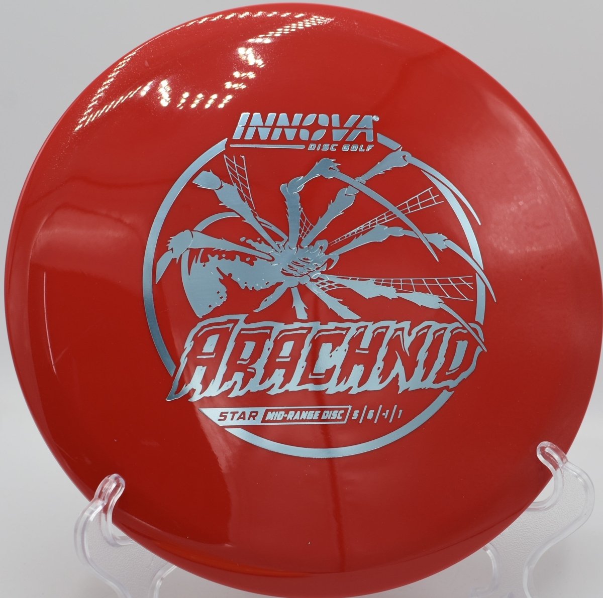 Innova Star Arachnid midrange gliding through wooded fairway gap at Hidden Lake Disc Golf Course in Martinez, Georgia