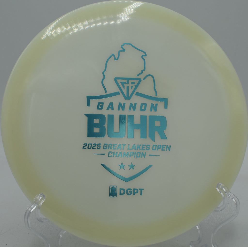 Glow C-Line FD2 Discmania Triumph Series 2025 Gannon Buhr edition glowing through wooded fairways at Northwood Black Disc Golf Course in Morton, Illinois.