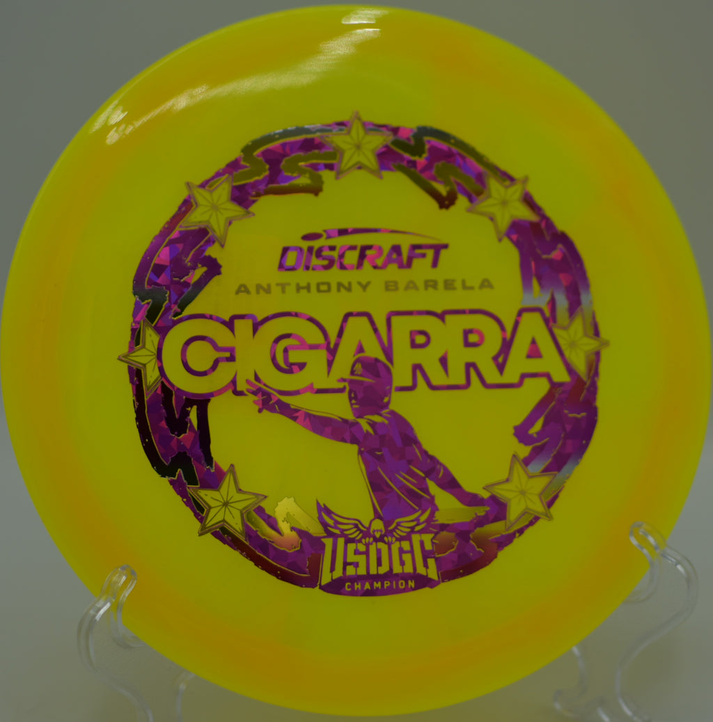 Discraft Cigarra in Z-Swirl resting near the creek at Memorial Hills DGC in Hopkinton, MA, showcasing its -1 turn finesse.