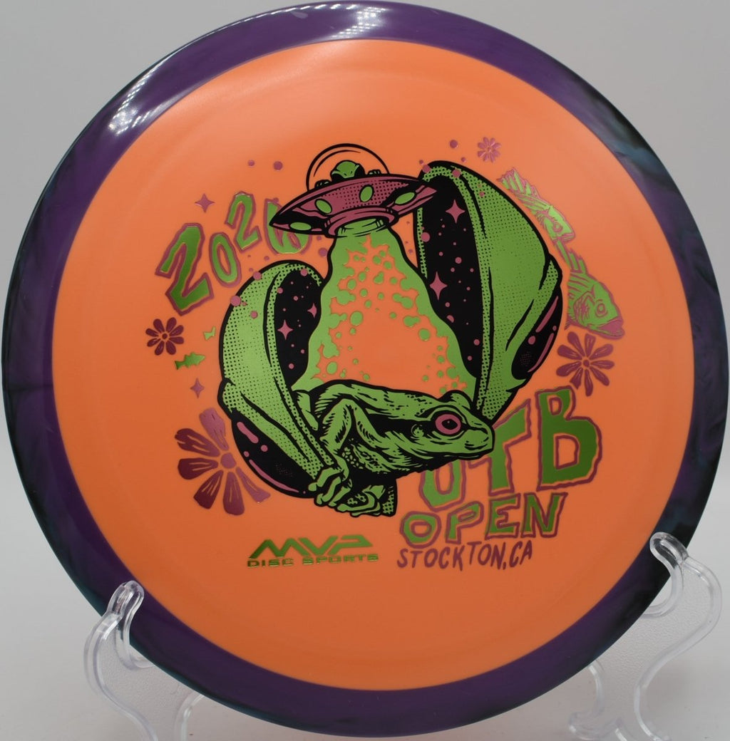 2026 OTB Open Delirium Fission plastic driver displayed near basket at Golden Gate Park Disc Golf Course in San Francisco, California