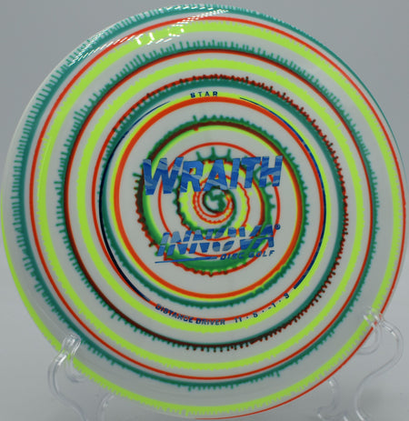 Close-up of an I-Dye Star Wraith mid-flight at Maple Hill Disc Golf Course in Leicester, Massachusetts