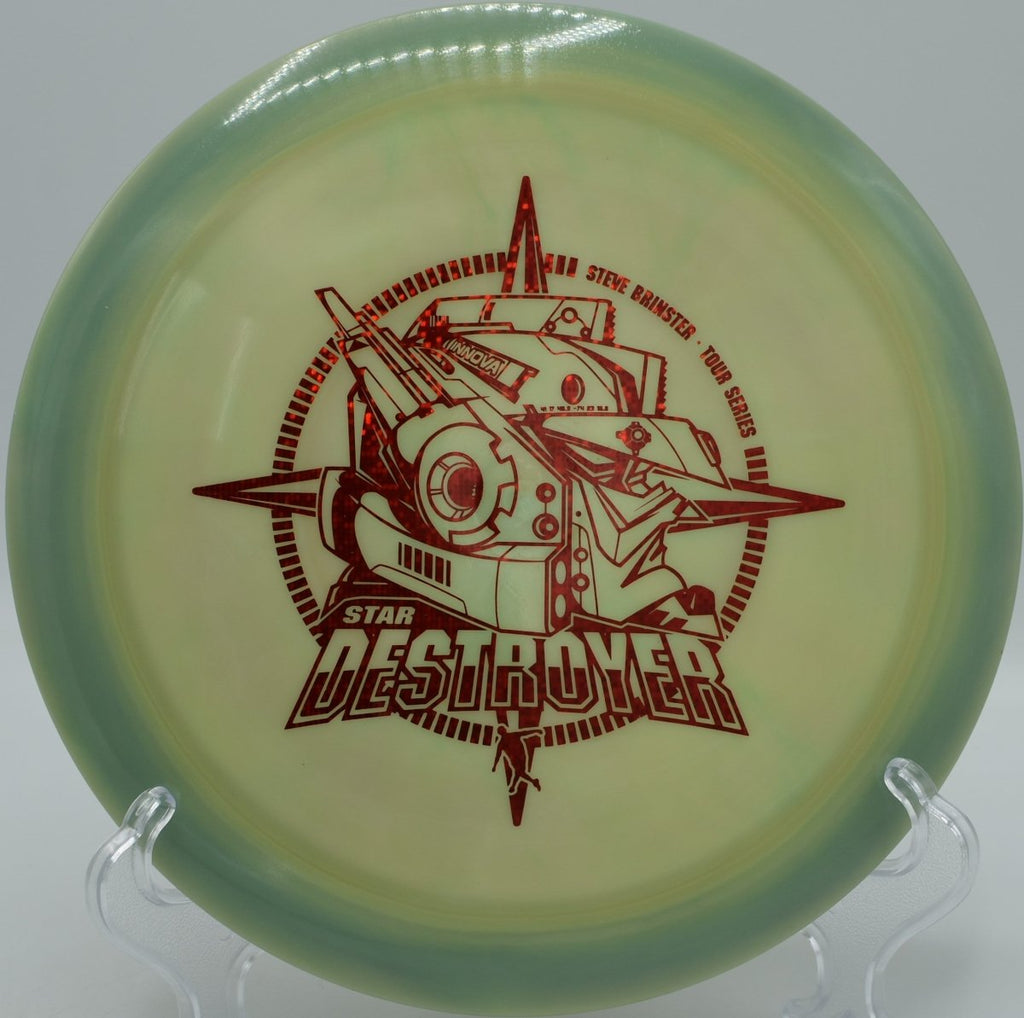 Brinster Star Destroyer driven low and hard into open air at Buffalo Ridge Disc Golf Course in Cedar Hill, Texas, maintaining wind-fighting overstability, forward push, and a crushing late finish for power-focused disc golf shots