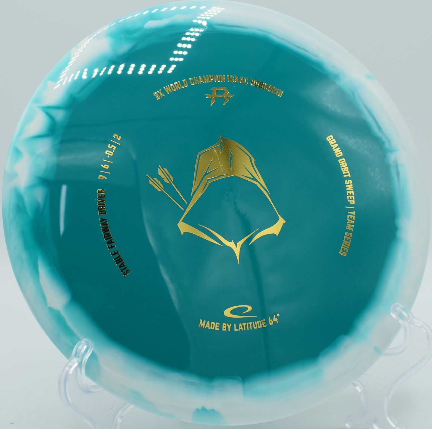 Grand Orbit Sweep in Team Series 2025 edition parked under the basket at Sabattus Disc Golf Course in Sabattus, Maine, showcasing its neutral flight and fade control.

