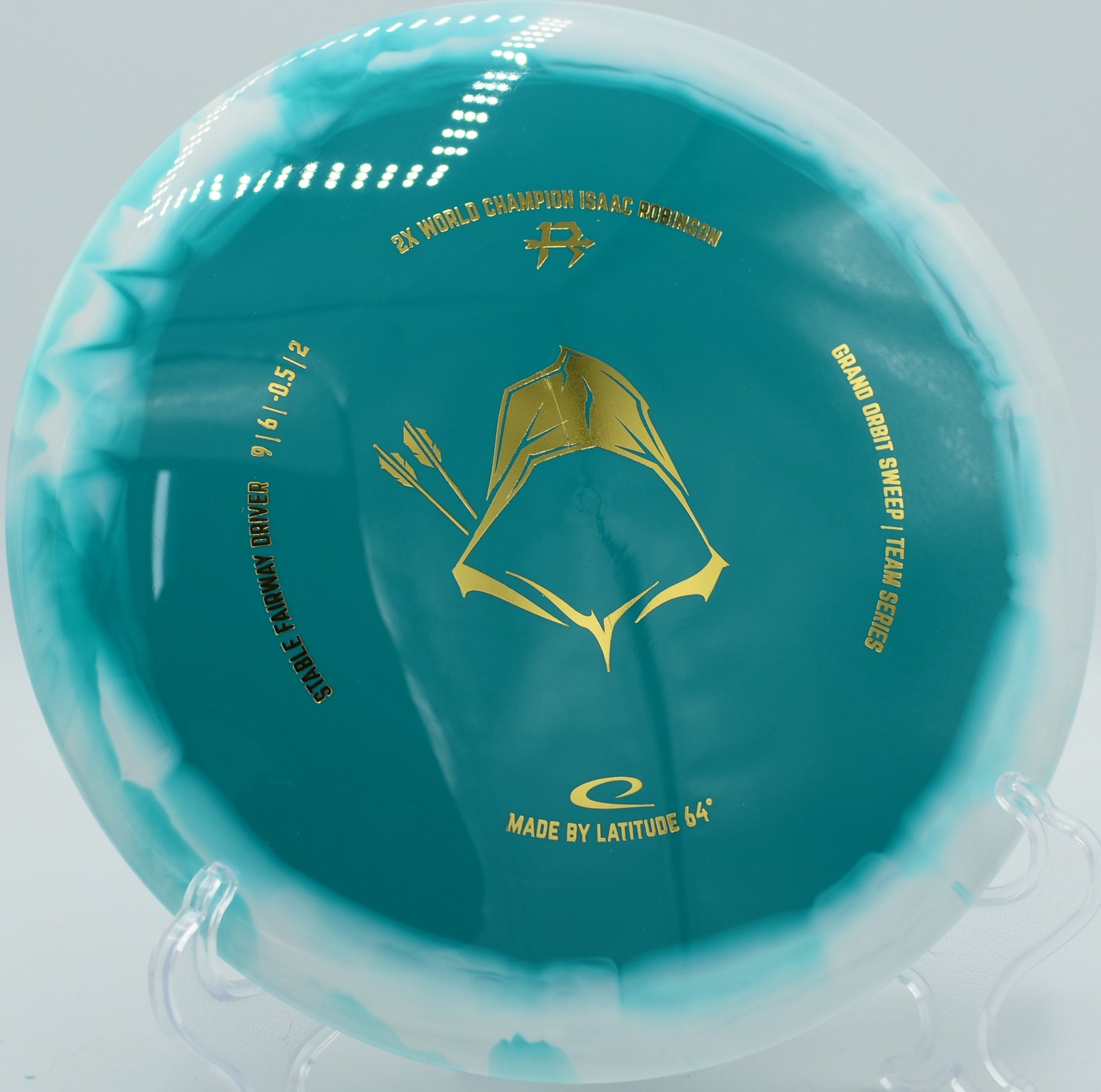 Grand Orbit Sweep in Team Series 2025 edition parked under the basket at Sabattus Disc Golf Course in Sabattus, Maine, showcasing its neutral flight and fade control.

