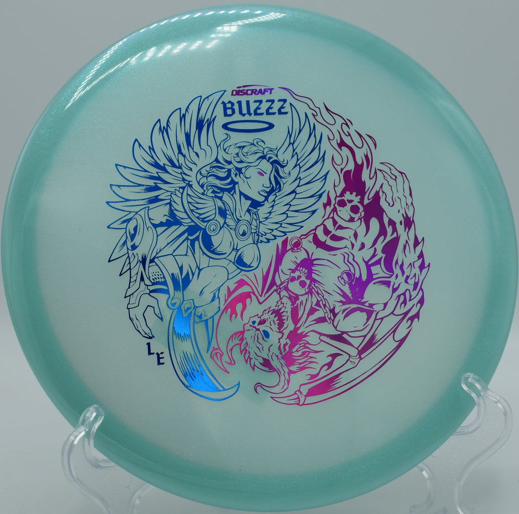 Z Glo Buzzz with shimmering colors resting on the fairway at Lake Marshall in Montross, Virginia, known for its visual appeal and point-and-shoot flight.

