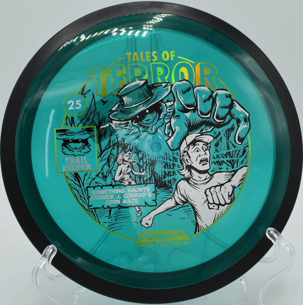 MVP Trail Proton Halloween disc streaking down a wooded fairway at The Fort in Ogden, Utah.