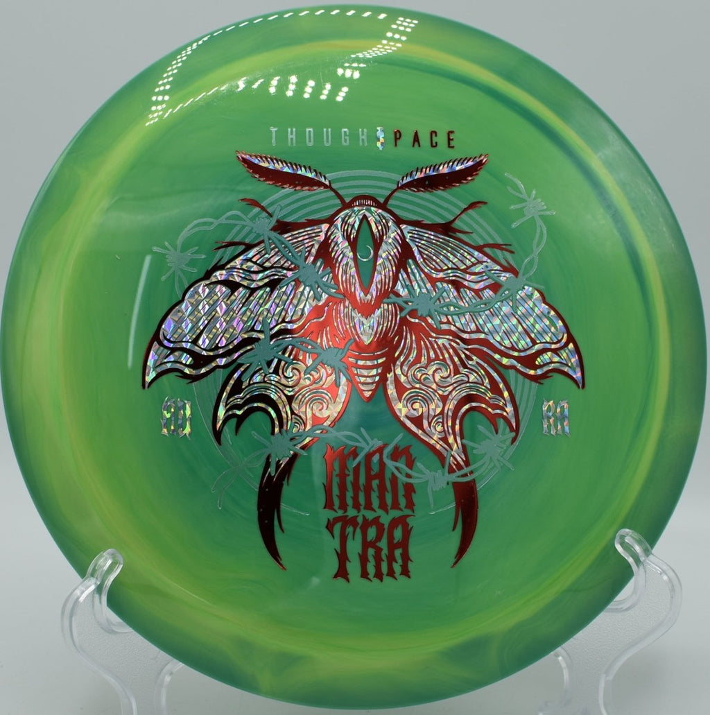 Mantra fairway driver carving a precise hyzer flip through trees at Heritage Park Disc Golf Course in Belton, Texas