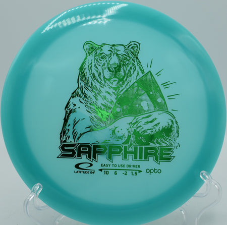 Latitude 64° Opto Moonshine Sapphire glowing distance driver parked on the fairway at Water Works Park Disc Golf Course in Kansas City, Missouri.