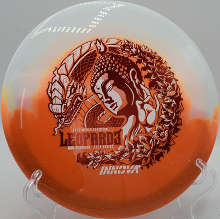 Duo Leopard3 Ohn Scoggins Tour Series fairway driver gliding toward basket chains at Wildcat Bluff Disc Golf Course in Urbana, Iowa