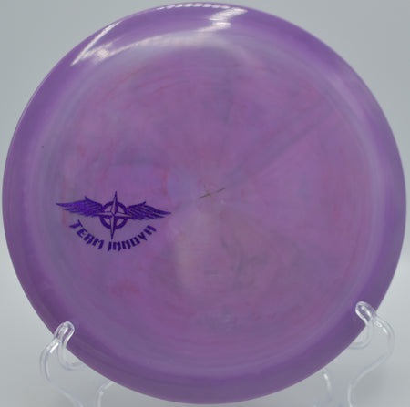 Innova Star Thunderbird (Team Stamp) ripping down a tight fairway on a powerful backhand drive at North Cove Disc Golf Course in Marion, North Carolina.