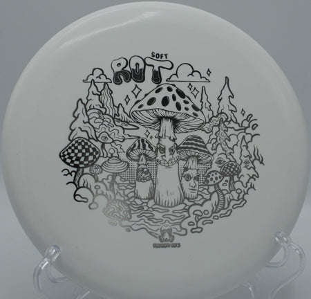 Ration Soft Rot beaded putter resting on the putting green beside the cage at Sunrise Disc Golf Course in Las Cruces, New Mexico