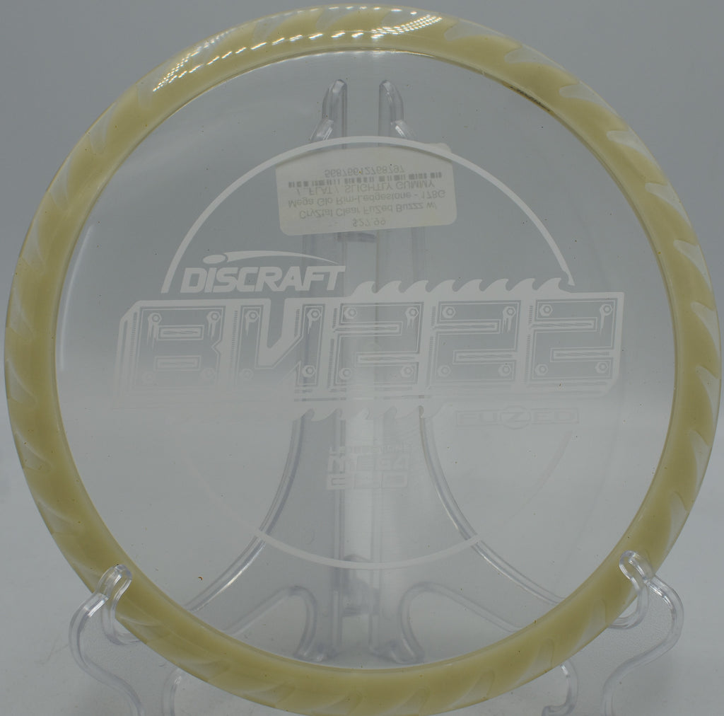Glow-rimmed CryZtal FLX BuzzzSaw launching from tee pad at Flip City Disc Golf Park, MI