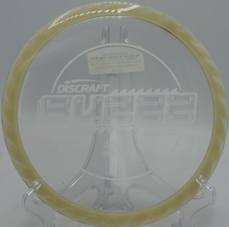 Glow-rimmed CryZtal FLX BuzzzSaw launching from tee pad at Flip City Disc Golf Park, MI