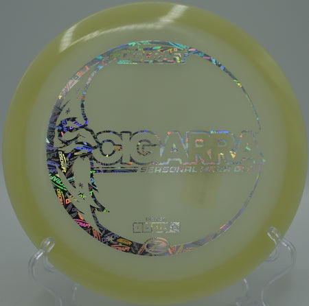 Mega Glow Z Cigarra parked beside the pin after a night-round drive at Northwood Black Disc Golf Course in Morton, Illinois.