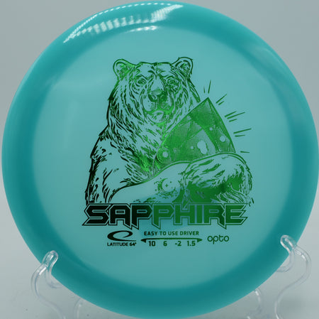 Opto Moonshine Sapphire Latitude 64° glow disc flipping up and gliding at Blue Ribbon Pines Disc Golf Course in East Bethel, Minnesota.