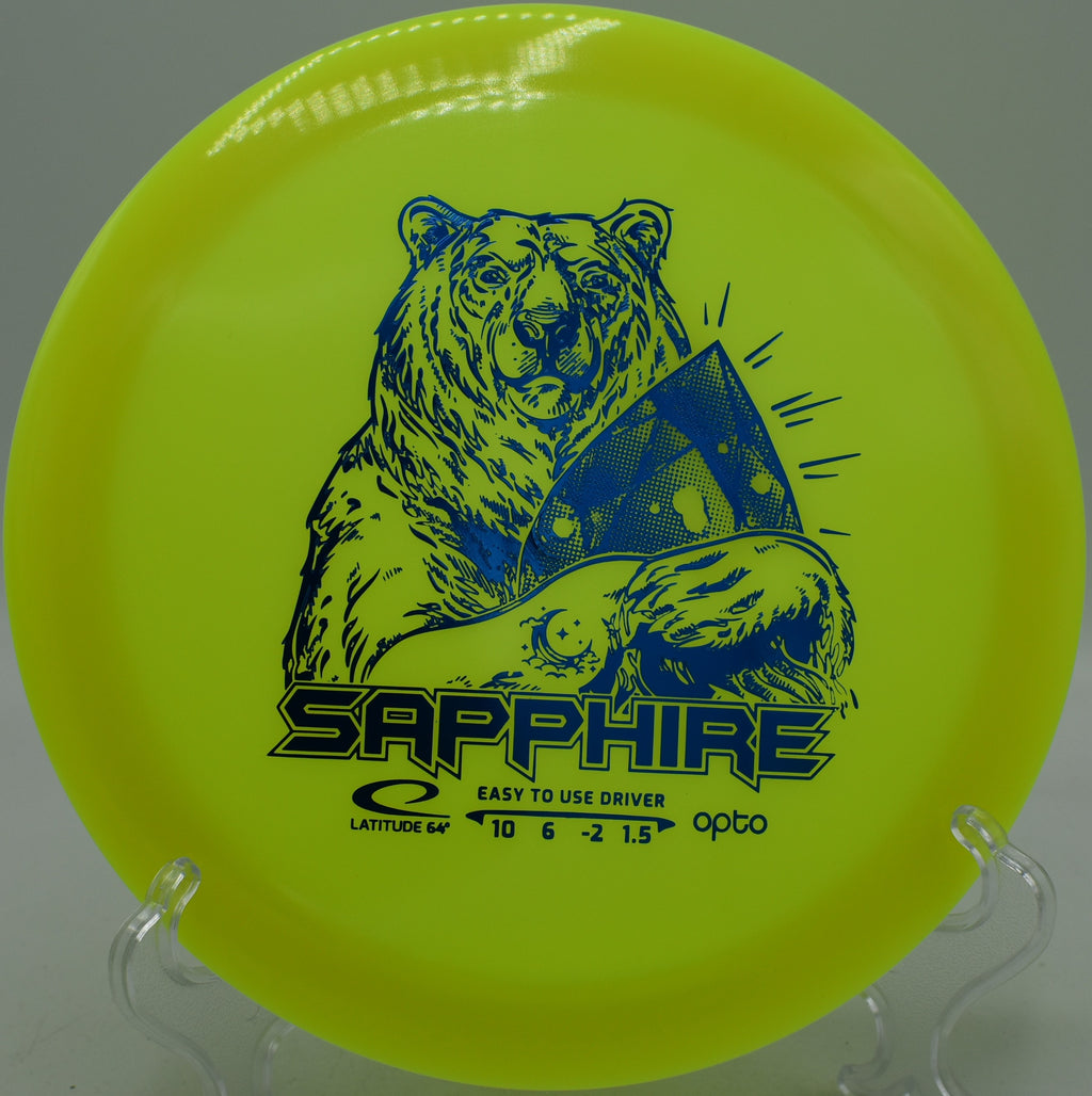 Opto Moonshine Sapphire Latitude 64° glowing disc holding a gentle S-curve at Northwood Black Disc Golf Course in Morton, Illinois.
