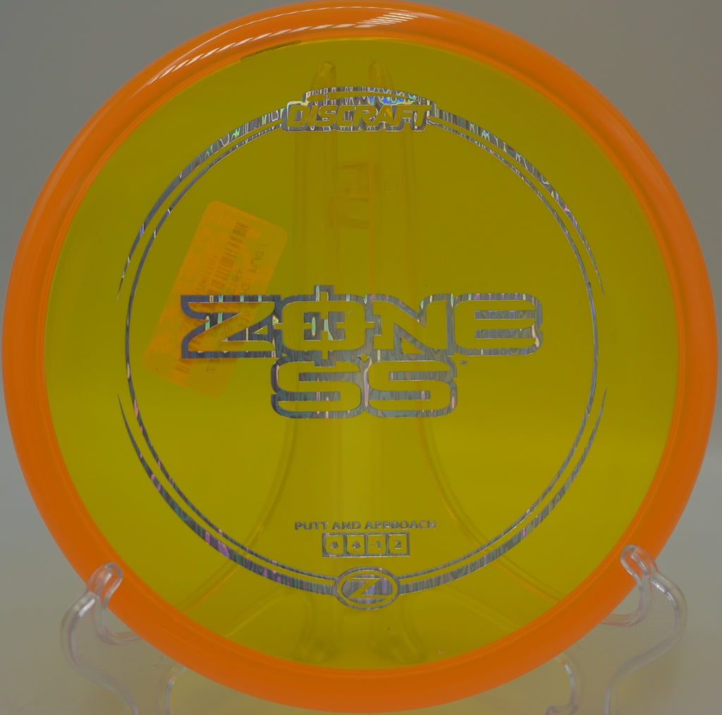 Player driving the Z Zone SS off the tee for a controlled shot at Shady Oaks Disc Golf Course in Orangevale, California.