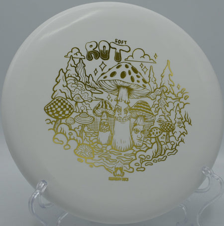 Ration Soft Rot putter lying beside the basket pole after a touch forehand upshot at Chisholm Trail Park Disc Golf Course in Round Rock, Texas