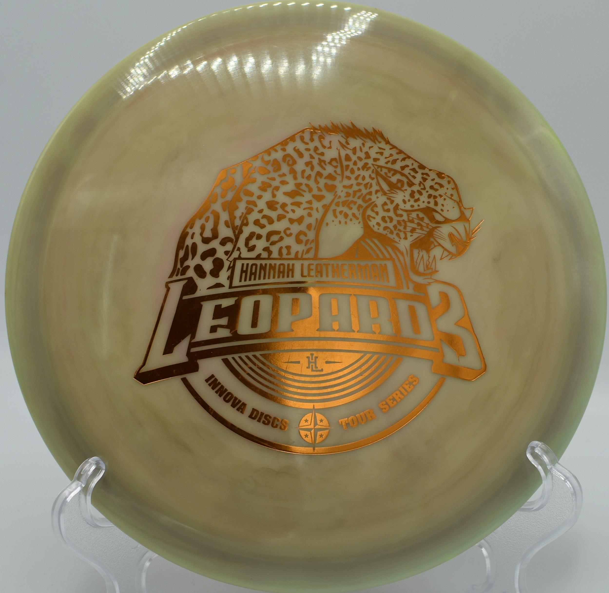 Swirly Star Leopard3 (2018 Hannah Leatherman) fairway driver gliding on a clean hyzer-flip through wooded lanes at Whistler’s Bend Disc Golf Course in Roseburg, Oregon, holding smooth turn, forward glide, and a soft finishing fade for precision disc golf control