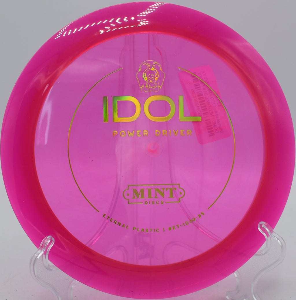 Mint Discs Eternal Idol disc shaping a flex shot through woods at Kaposia Park Disc Golf Course in South St. Paul, Minnesota