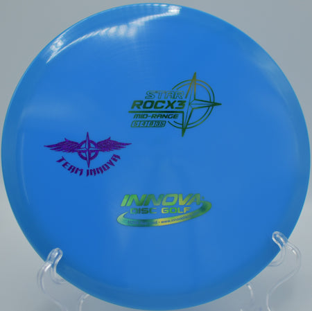 Innova Star RocX3 (Team Stamp) ripping through a headwind on a controlled hyzer line at North Cove Disc Golf Course in Marion, North Carolina.