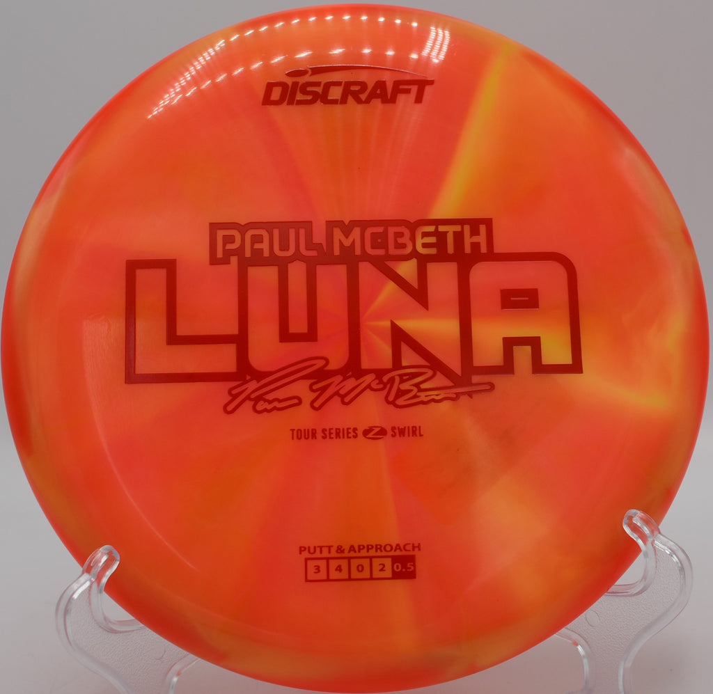 Discraft Z Swirl Luna resting on moss at Moraine State Park in Portersville, Pennsylvania, built for precision approaches and clean releases.

