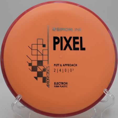 Electron Firm Pixel putter lying beside the basket pole after a straight upshot at The Rez Disc Golf Course in Brandon, Mississippi